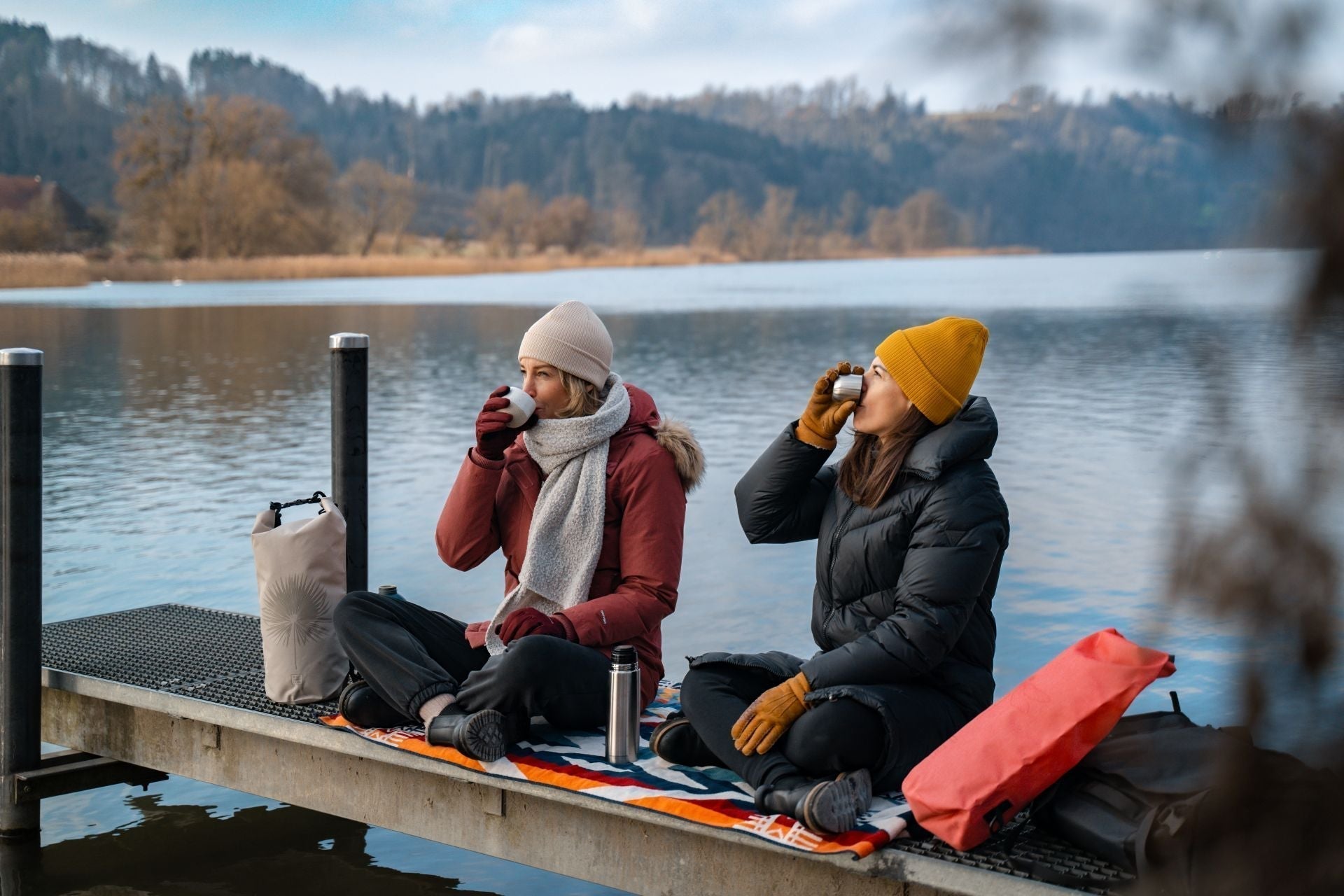 Am Wasser sitzend mit Tee in der Hand